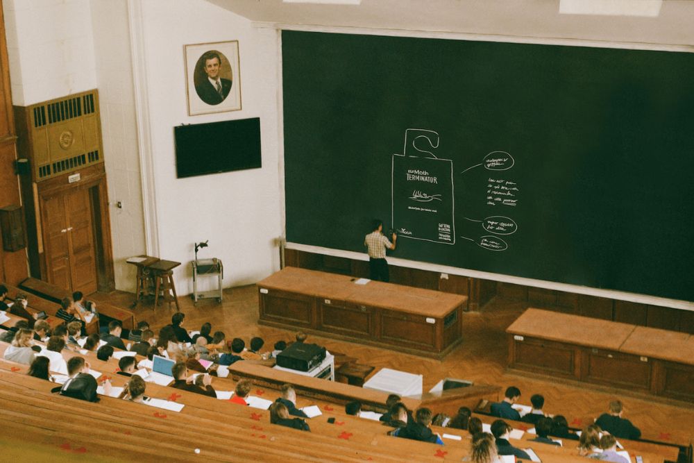 A classroom with an Eco Terminator Moth Trap drawn on the black board.